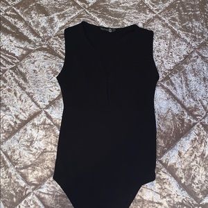 Black deep v cut bodysuit. Never worn